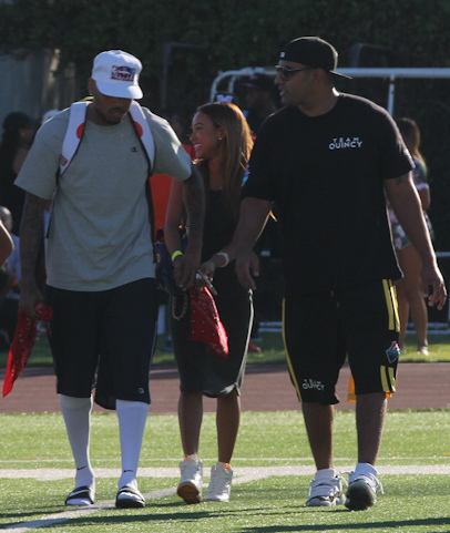 Chris Brown cuddles up to on/off girlfriend Karrueche Tran as they attend his charity footbal game in Los Angeles, CA