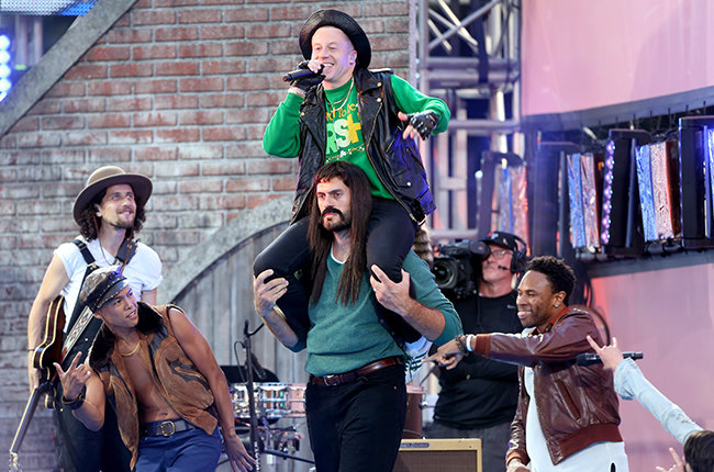 LOS ANGELES, CA - AUGUST 30: Recording artist Macklemore (center) performs on the Pepsi Stage, during the 2015 MTV Video Music Awards, at The Orpheum Theatre on August 30, 2015 in Los Angeles, California. (Photo by Frederick M. Brown/Getty Images for MTV)