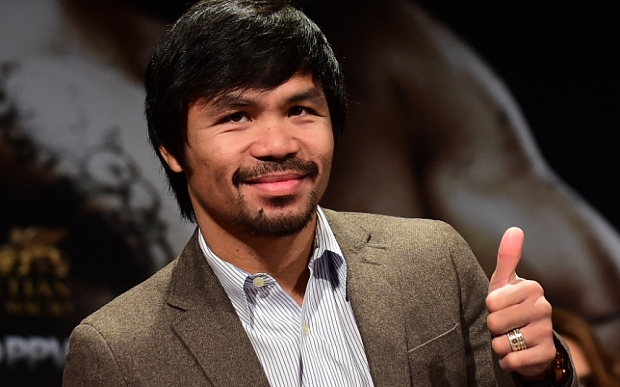 (FILES) In this September 3, 2014 file photo, Filipino boxing star Manny Pacquiao gestures on arrival for a press conference with fellow boxer Chris Algieri in Los Angeles, California. Pacquiao called his boxing showdown with Floyd Mayweather "the fight of my life" as he got down to work pounding the streets and gym in Los Angeles. The eight-division world champion cranked into serious preparations for the May 2 fight after flying in for his training camp from his native Philippines. On March 2, 2015, Pacquiao ran two miles (3.2 km) and shadow-boxed for two rounds, followed by abdominal work and breakfast of steamed rice, scrambled egg, fish and chicken broth. AFP PHOTO / FREDERIC J. BROWN / FILESFREDERIC J. BROWN/AFP/Getty Images